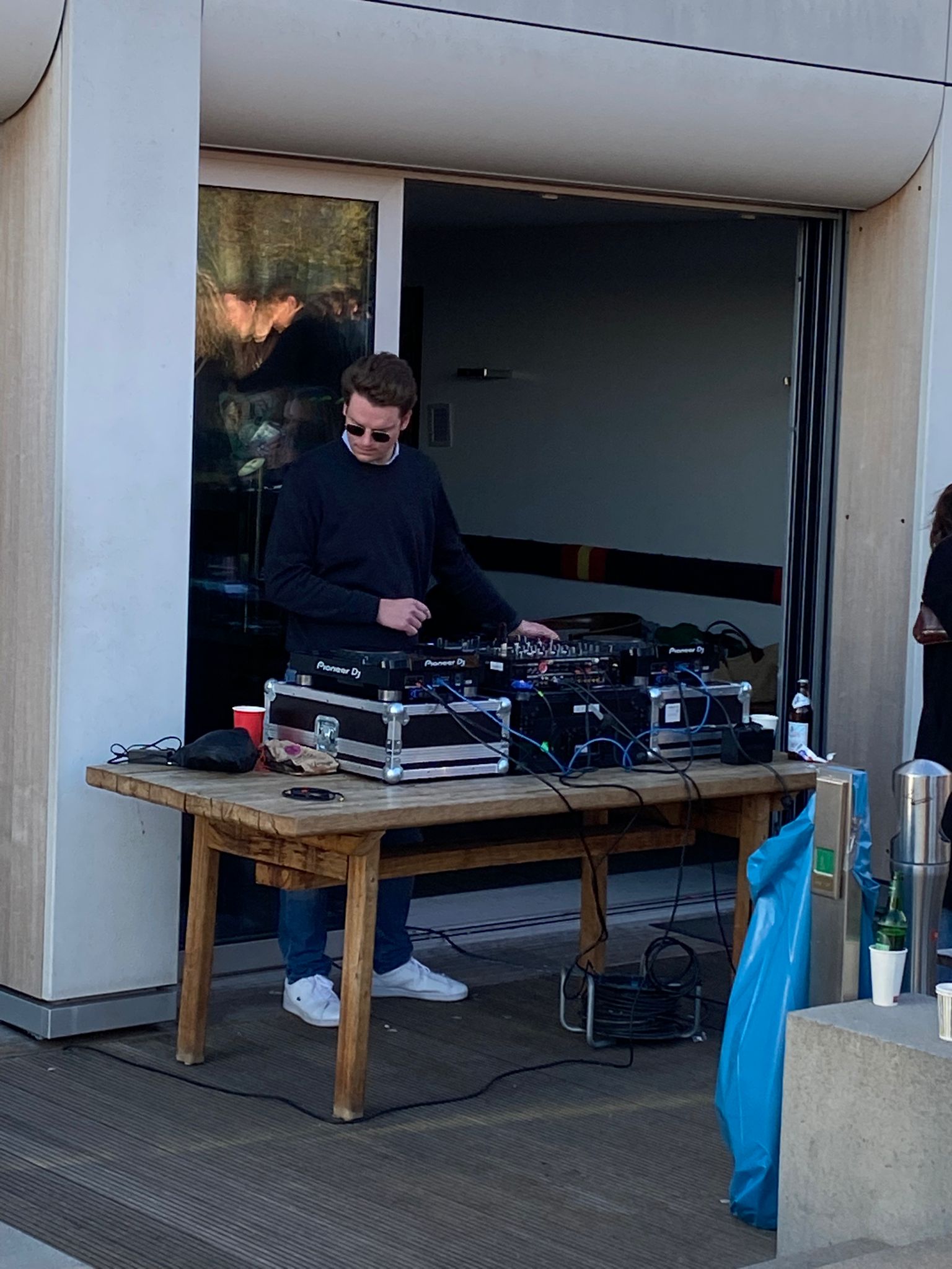 noelgon at an outdoor event, daylight setup on Pioneer DJ decks.